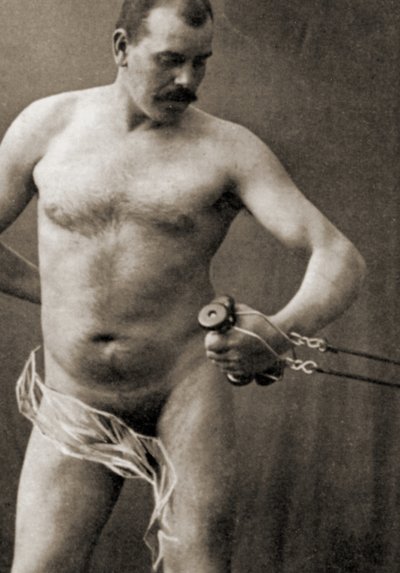 Nude Male Holding the Handle of a Cable Machine by Unknown